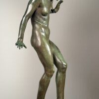 Alt text: Bronze sculpture of a young nude woman standing among frogs