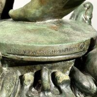Alt text: Bronze sculpture, signature detail