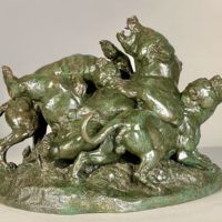 Alt text: Bronze sculpture of a bear attacked by hounds