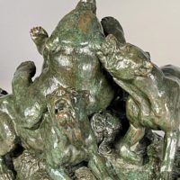 Alt text: Bronze sculpture of a bear attacked by hounds