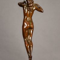 Alt text: Bronze sculpture of a nude woman standing with elbows out and hands framing her face