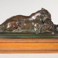Alt text: Bronze sculpture of a tiger devouring a gazelle
