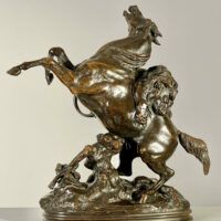 Alt text: Bronze sculpture of a lion attacking a horse