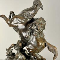 Alt text: Bronze sculpture of a lion attacking a horse