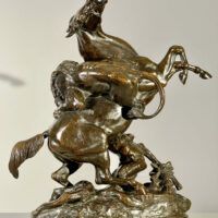 Alt text: Bronze sculpture of a lion attacking a horse