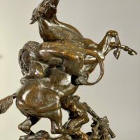 Alt text: Bronze sculpture of a lion attacking a horse