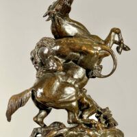 Alt text: Bronze sculpture of a lion attacking a horse