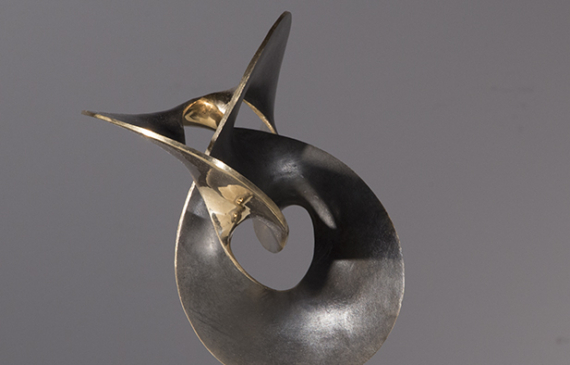 Alt text: Abstract bronze sculpture of distorted and conjoined ovular shapes