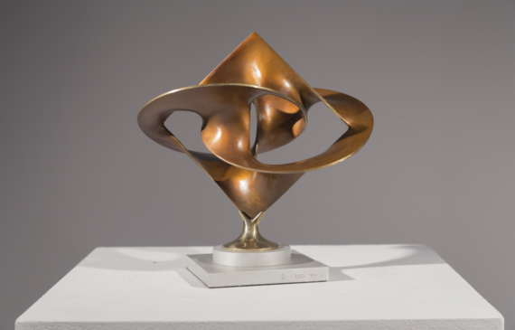 Alt text: Abstract bronze sculpture of distorted and conjoined spheres