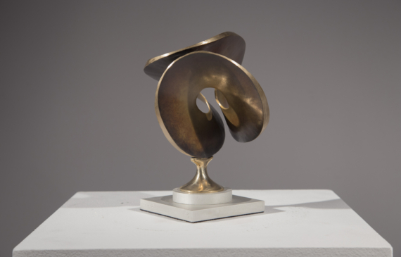 Alt text: Abstract bronze sculpture of a single distorted and conjoined circle