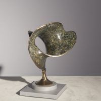 Alt text: Abstract bronze sculpture of two distorted and conjoined circles