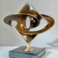 Alt text: Geometric bronze sculpture with brown patina