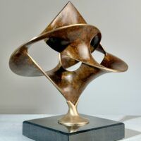 Alt text: Geometric bronze sculpture with brown patina