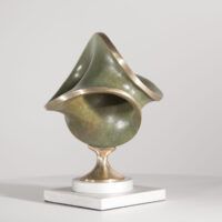 Alt text: Round bronze sculpture