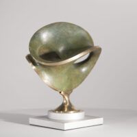 Alt text: Round bronze sculpture