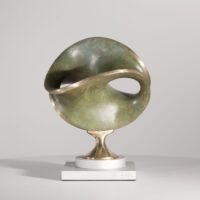 Alt text: Round bronze sculpture