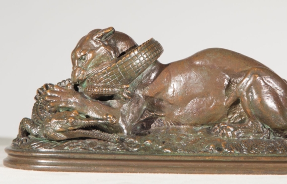 Alt text: Bronze sculpture of a tiger eating a gavial