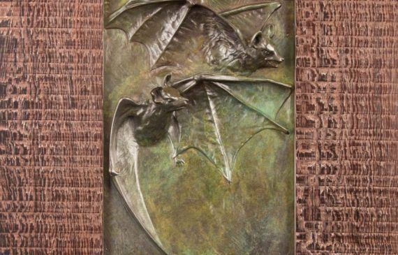 Alt text: Relief of two flying bats