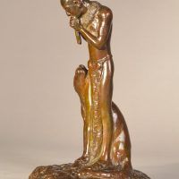 Alt text: Bronze sculpture of a Native American man playing flute, looking down at a Puma sitting beside him, angled view