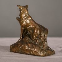 Alt text: Bronze sculpture of two coyotes nuzzling each other