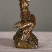 Alt text: Bronze sculpture of two coyotes nuzzling each other