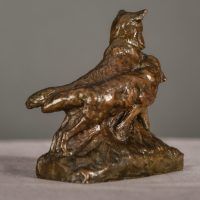 Alt text: Bronze sculpture of two coyotes nuzzling each other