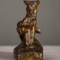 Alt text: Bronze sculpture of two coyotes nuzzling each other