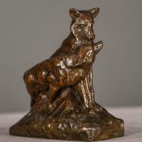 Alt text: Bronze sculpture of two coyotes nuzzling each other