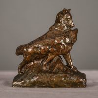 Alt text: Bronze sculpture of two coyotes nuzzling each other