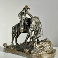 Alt text: Bronze sculpture of a man with horses