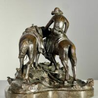 Alt text: Bronze sculpture of a man with horses