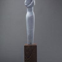 Alt text: Abstract blue alabaster sculpture resembling the female form