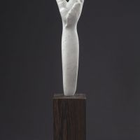 Alt text: Abstract white alabaster sculpture resembling the female form, detail