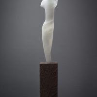 Alt text: Abstract white alabaster sculpture resembling the female form