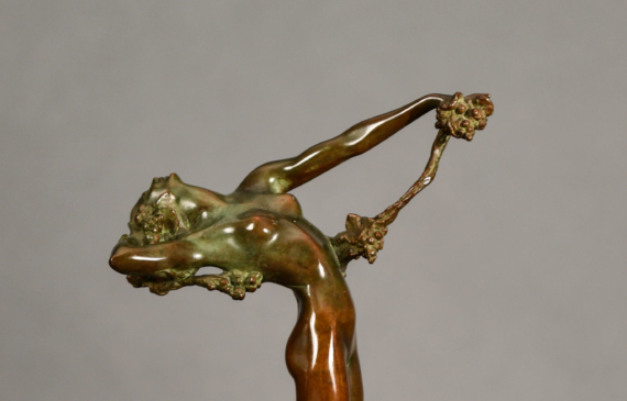 Alt text: Bronze sculpture of a nude woman with back arched, holding a vine in her extended left hand draping over her body
