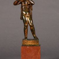 Alt text: Bronze sculpture of an angel playing flute