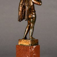 Alt text: Bronze sculpture of an angel playing flute