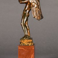 Alt text: Bronze sculpture of an angel playing flute