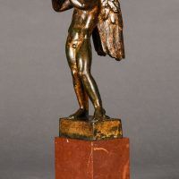 Alt text: Bronze sculpture of an angel playing flute