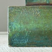 Alt text: Bronze sculpture, signature and foundry detail