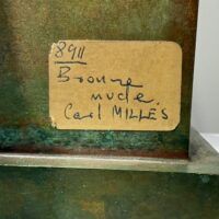 Alt text: Bronze sculpture, sticker label detail