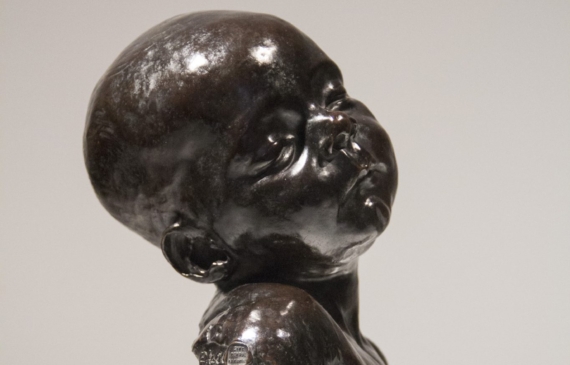 Alt text: Bronze bust of an infant head