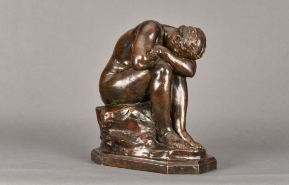 Alt text: Bronze sculpture of a seated nude woman bent over crying into her arms