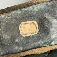 Alt text: Bronze sculpture, underside view, detail
