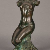 Alt text: Bronze sculpture of a headless and armless seated female nude