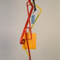 Alt text: Abstract kinetic sculpture of painted welded steel with three hanging/movable pieces, frontal view