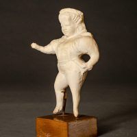 Plaster figure of a circus performer, angled view