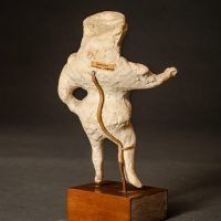 Plaster figure of a circus performer, angled view