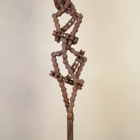 Alt text: Welded chain link sculpture with biomorphic figure, rear view