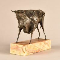 Alt text: Bronze modernist sculpture of a bull atop a marble base